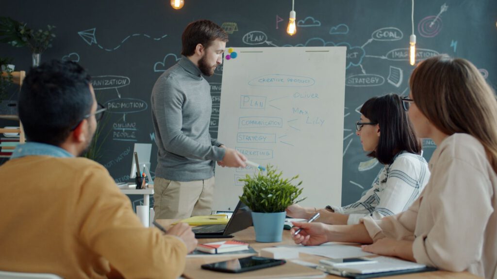 Trainer presenting at a flip chart to a small group