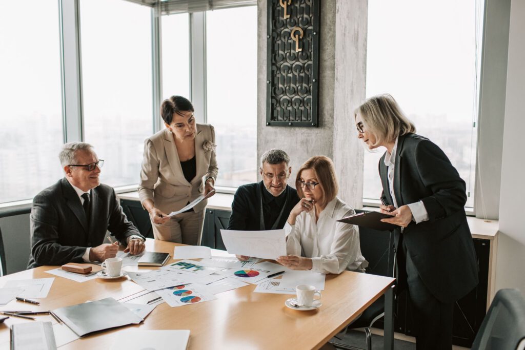 Business team reviewing documents and charts at a conference table