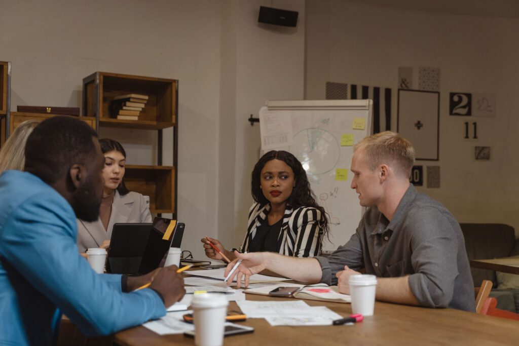 Colleagues in discussion around a meeting table